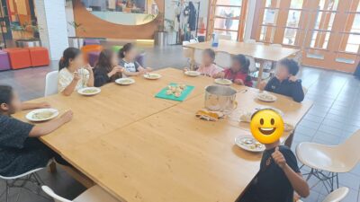 Children eat soup during after-school activity cooking